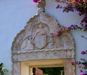 A carved stone frieze frames a doorway into a garden at the Casa del Herrero estate in Montecito,California