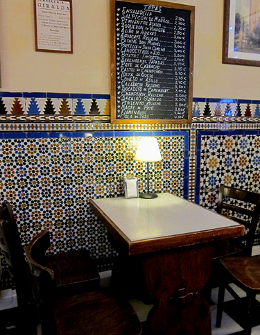 Classic Spanish tile installed at a tapas bar in the historic district of Seville, Spain